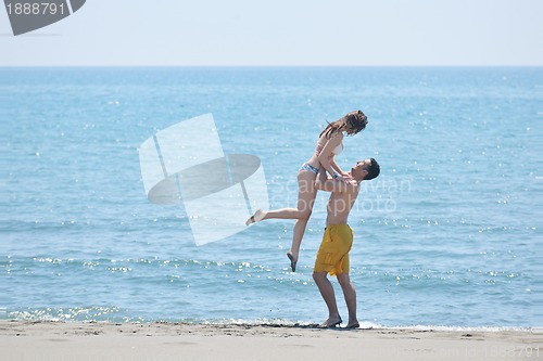 Image of happy young couple have romantic time on beach