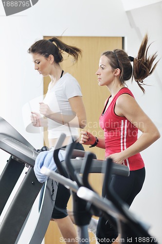 Image of woman workout  in fitness club on running track 