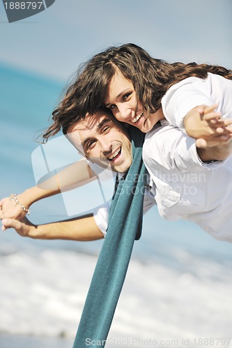 Image of happy young couple have fun at beautiful beach