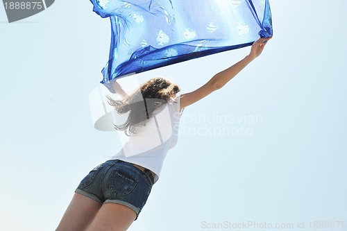 Image of beautiful young woman on beach with scarf