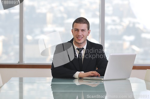 Image of young business man alone in conference room