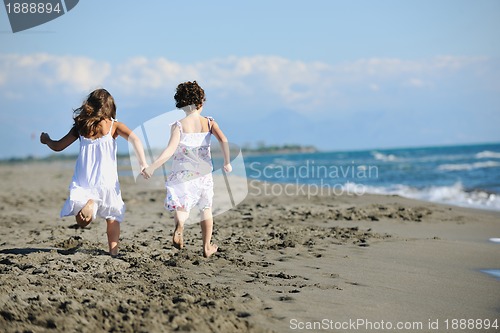 Image of cute little girls running on beach