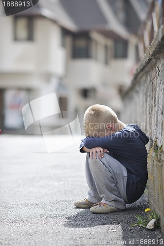 Image of sad lonely boy on street