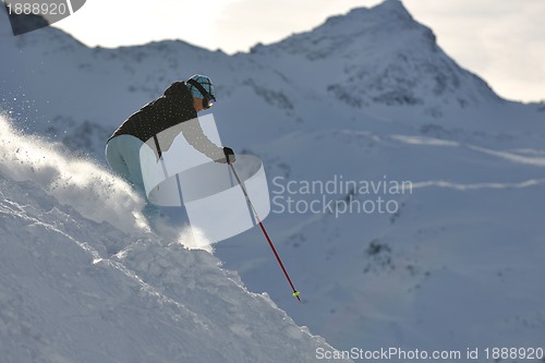 Image of woman skiing on fresh snow at winter season 
