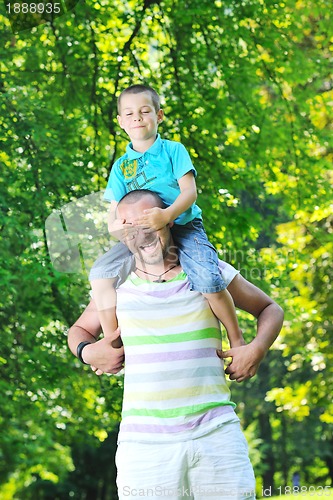 Image of happy father and son have fun at park