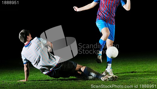 Image of football players in competition for the ball