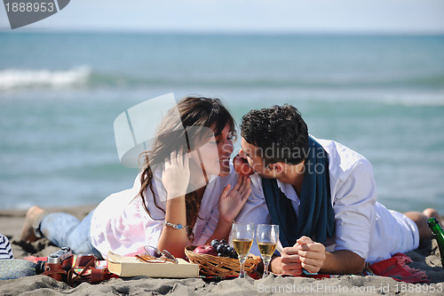 Image of young couple enjoying  picnic on the beach