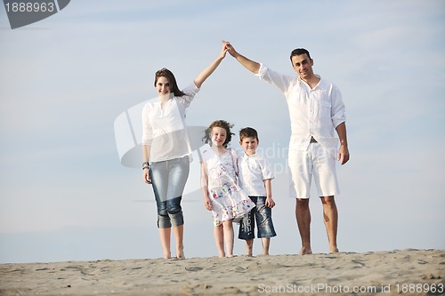 Image of family on beach showing home sign