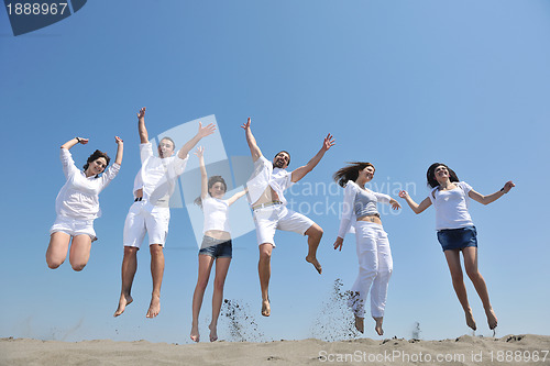 Image of happy people group have fun and running on beach
