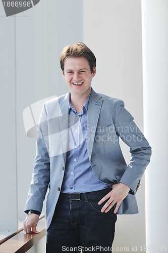 Image of young business man alone in conference room
