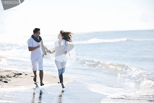 Image of happy young couple have fun at beautiful beach
