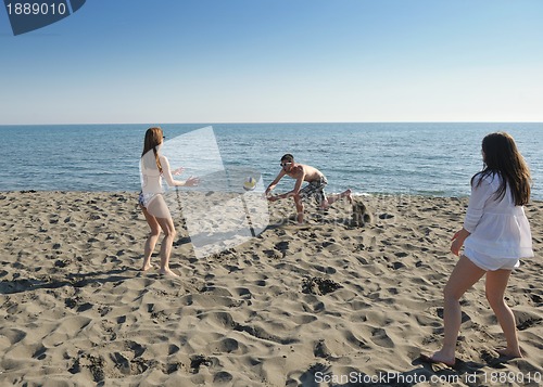 Image of young people group have fun and play beach volleyball