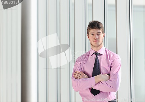 Image of young business man alone in conference room