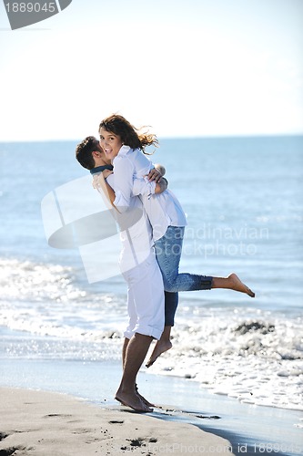 Image of happy young couple have fun at beautiful beach