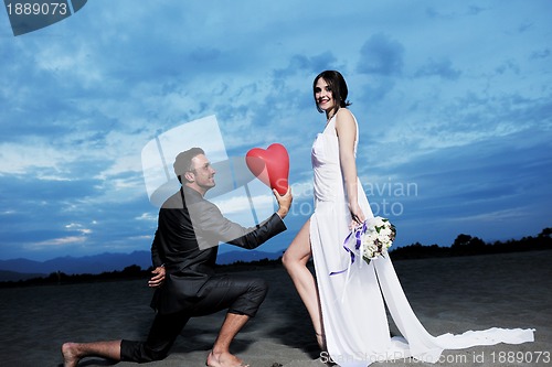 Image of romantic beach wedding at sunset
