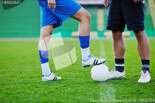 Image of football players in competition for the ball