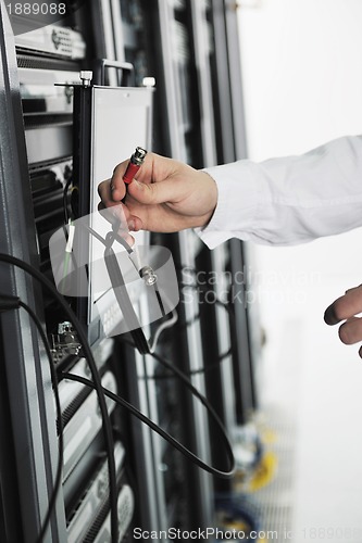 Image of young it engeneer in datacenter server room