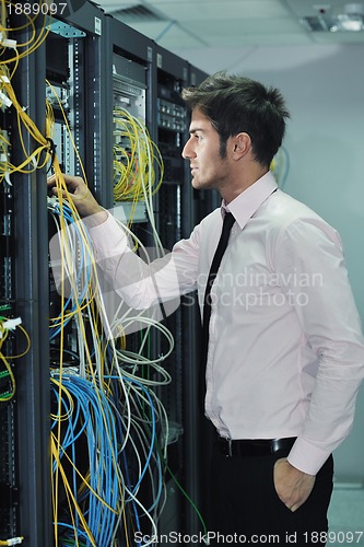 Image of young it engineer in datacenter server room