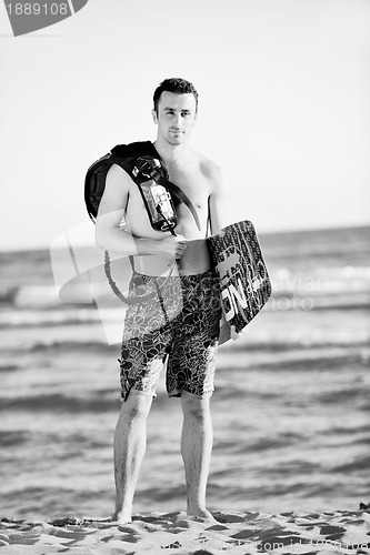 Image of Portrait of a young  kitsurf  man at beach on sunset