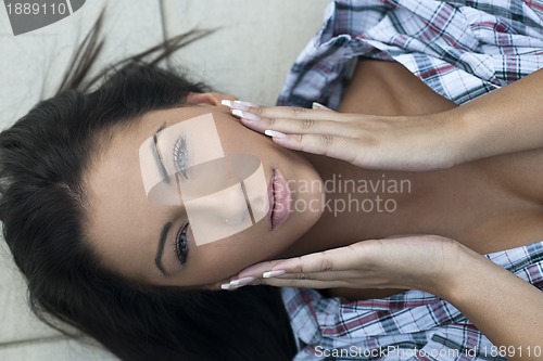 Image of beautiful young lady posing in garden