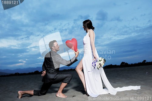 Image of romantic beach wedding at sunset