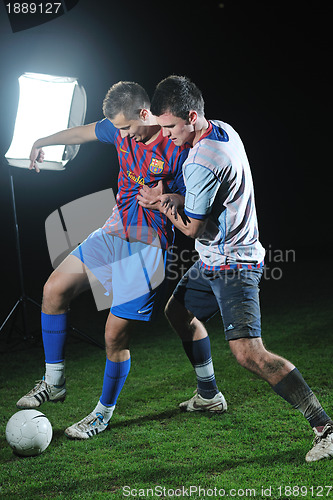 Image of football players in competition for the ball