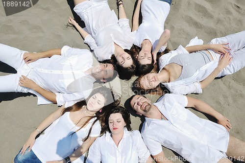 Image of Group of happy young people in have fun at beach