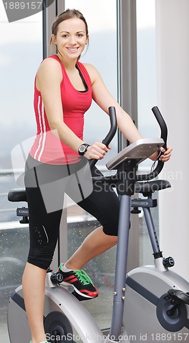 Image of woman workout  in fitness club on running track 