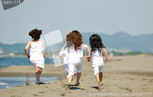 Image of happy child group playing  on beach