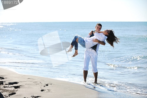 Image of happy young couple have fun at beautiful beach