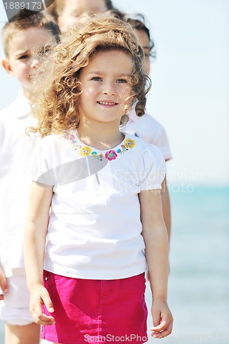 Image of happy child group playing  on beach