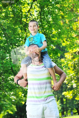 Image of happy father and son have fun at park