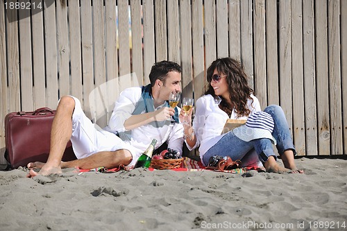 Image of young couple enjoying  picnic on the beach