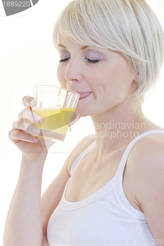 Image of Young woman squeeze orange juice