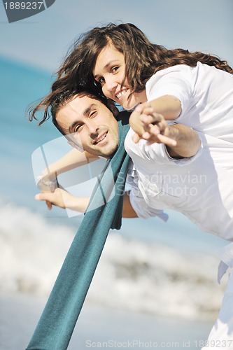 Image of happy young couple have fun at beautiful beach
