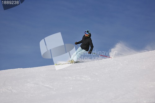 Image of woman skiing on fresh snow at winter season 