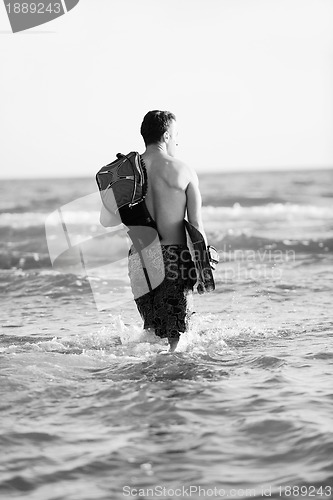 Image of Portrait of a young  kitsurf  man at beach on sunset