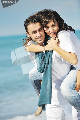 Image of happy young couple have fun at beautiful beach