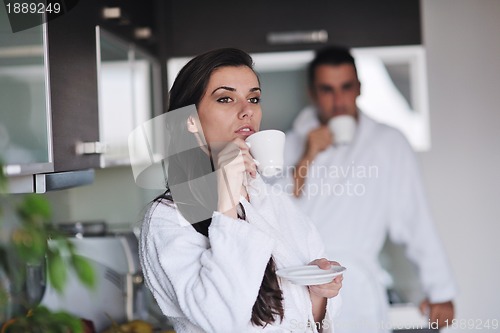 Image of Young love couple taking fresh morning cup of coffee