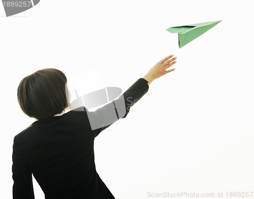 Image of business woman throwing  paper airplane 
