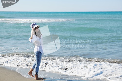 Image of happy young woman on beach