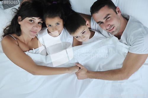 Image of happy young Family in their bedroom