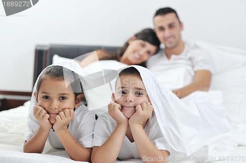 Image of happy young Family in their bedroom