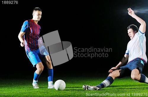 Image of football players in competition for the ball
