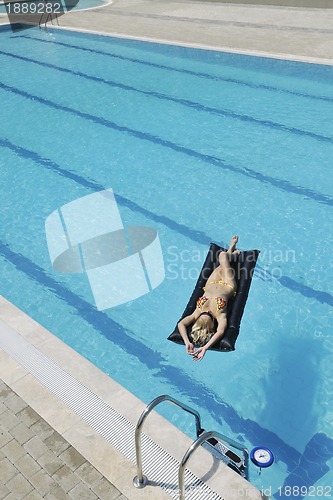 Image of woman relax on swimming pool