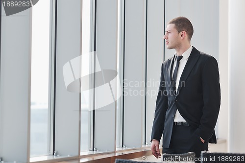 Image of young business man alone in conference room