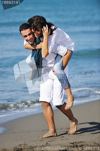 Image of happy young couple have fun at beautiful beach