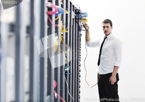 Image of young it engeneer in datacenter server room