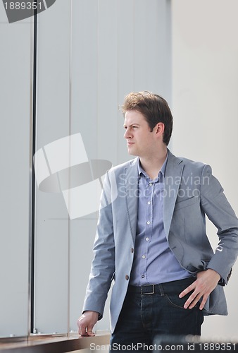 Image of young business man alone in conference room