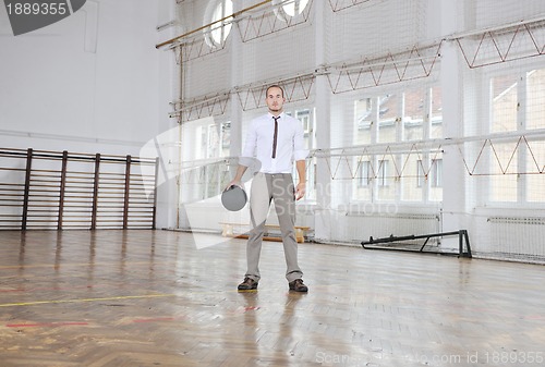 Image of businessman holding basketball ball